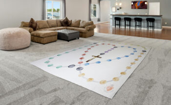 A walkable rosary blanket in a living room